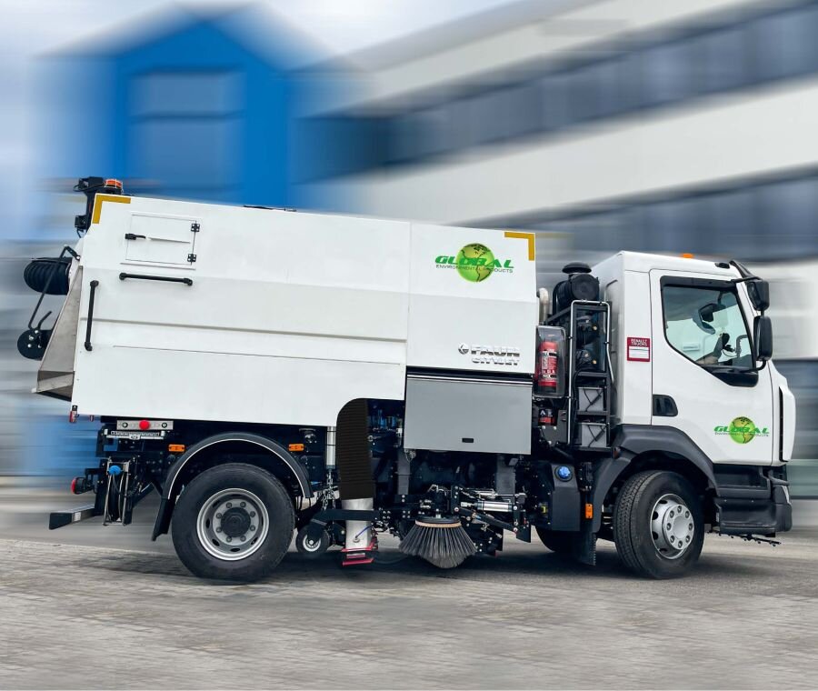 White Global city sweeper truck with side broom, shown with a motion-blurred background